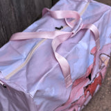 Pastel pink droving duffle bag print close-up showing detailed droving cattle print in pastel pink
