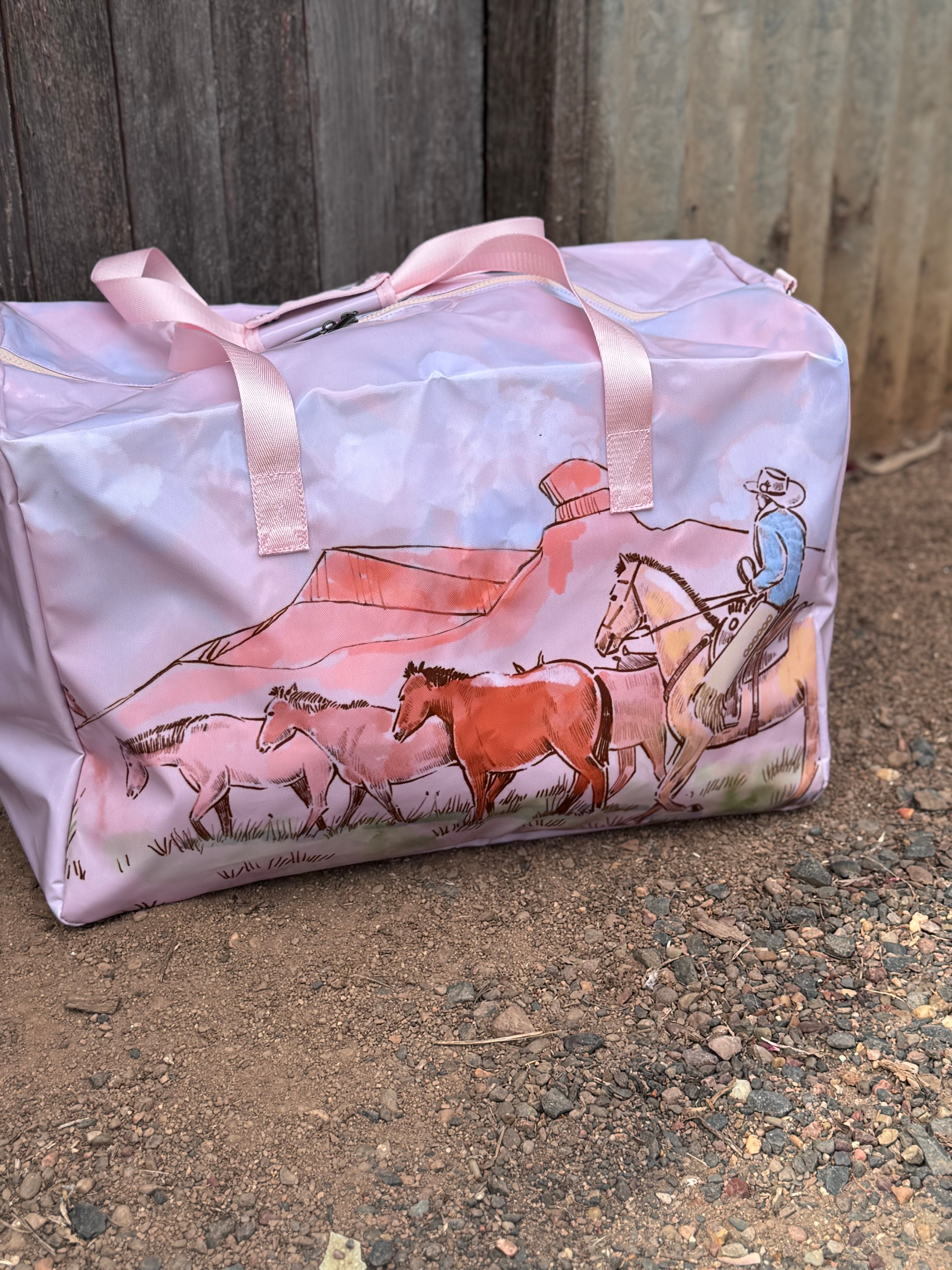 Pastel pink droving duffle bag open showing spacious interior and quality zip closure