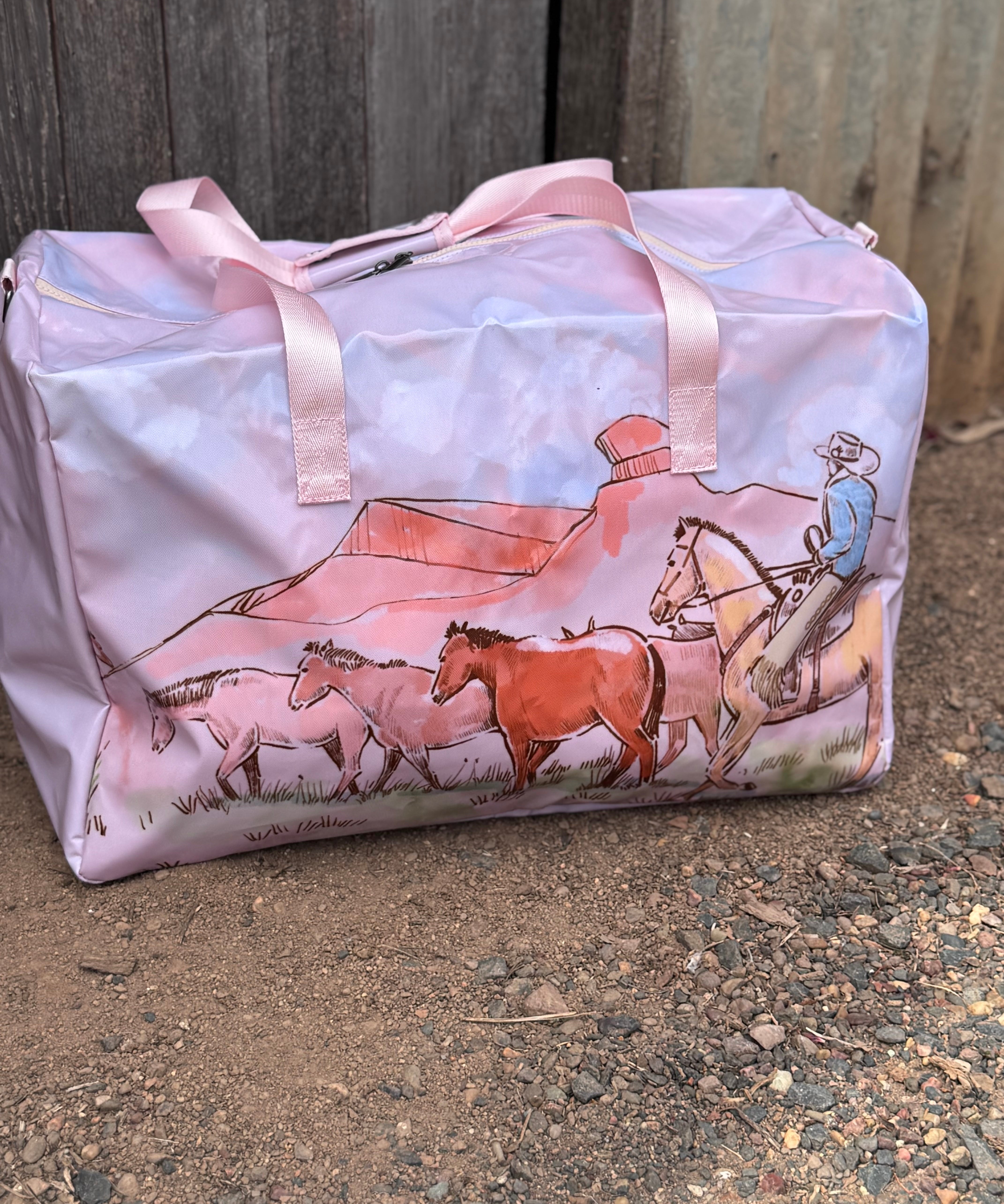 Pastel pink droving duffle bag side view showing roomy compartment and soft pink colourway
