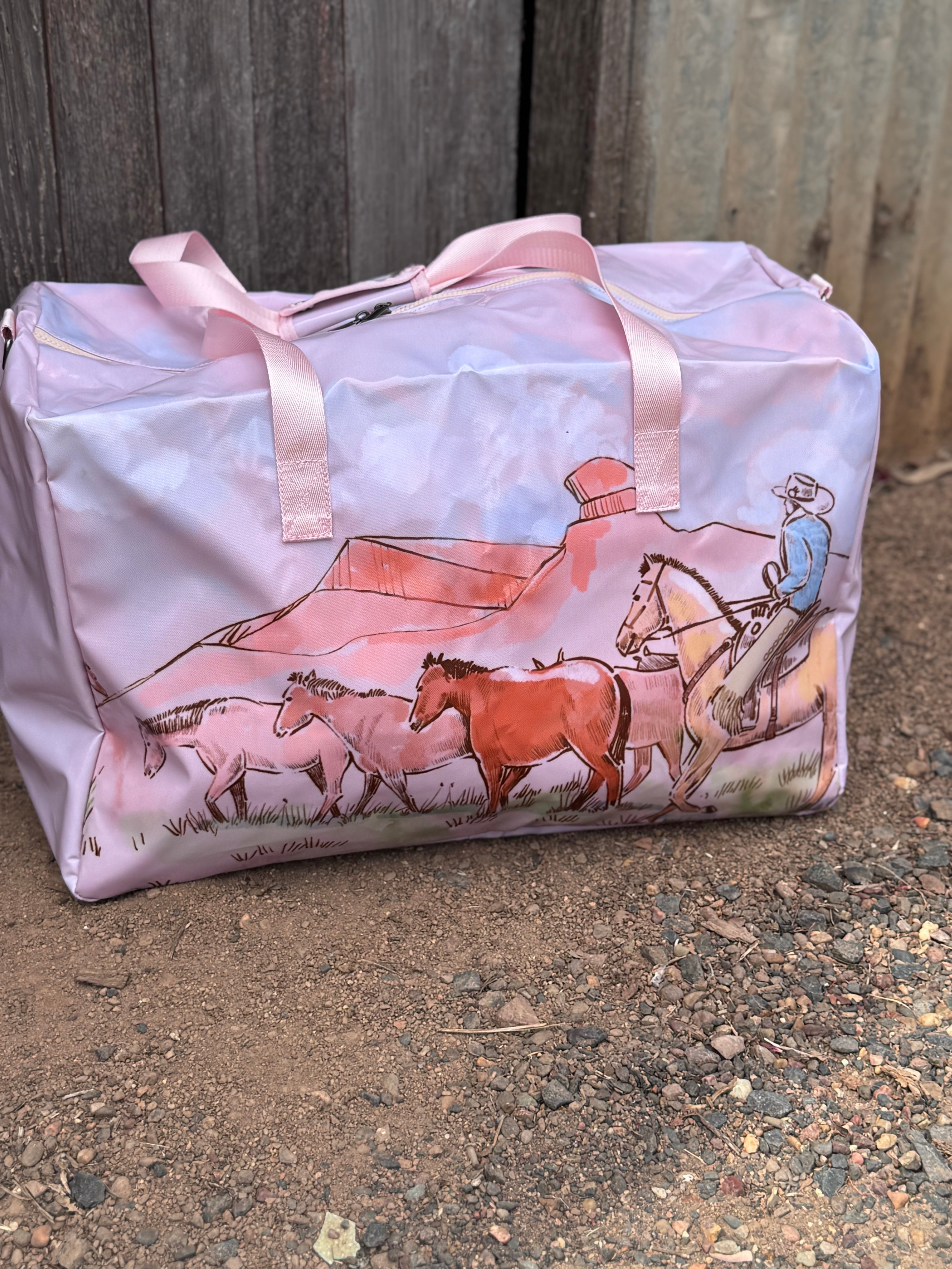 Pastel pink droving duffle bag side view showing roomy compartment and soft pink colourway