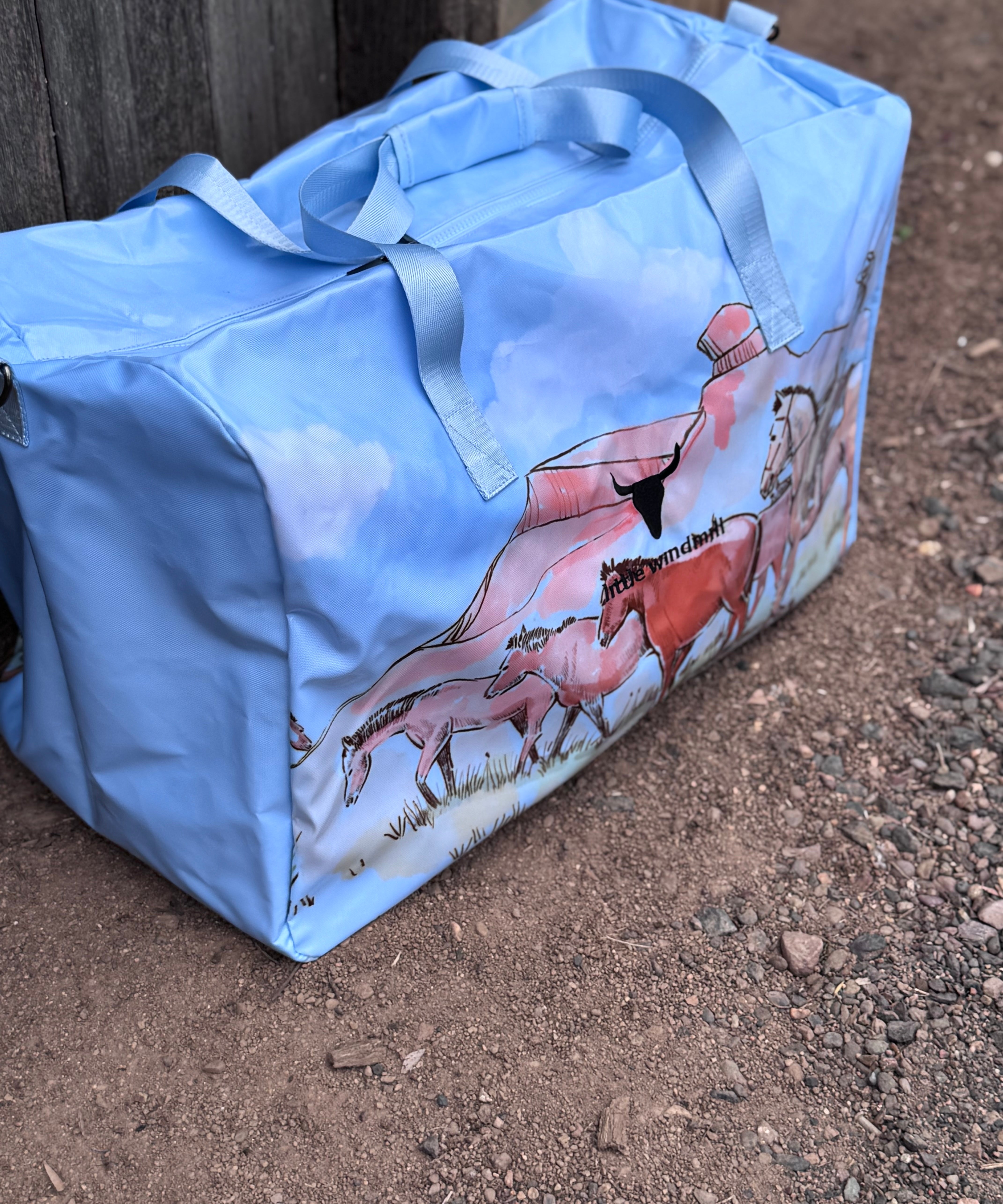 Pastel blue droving duffle bag open showing spacious interior and quality zip closure