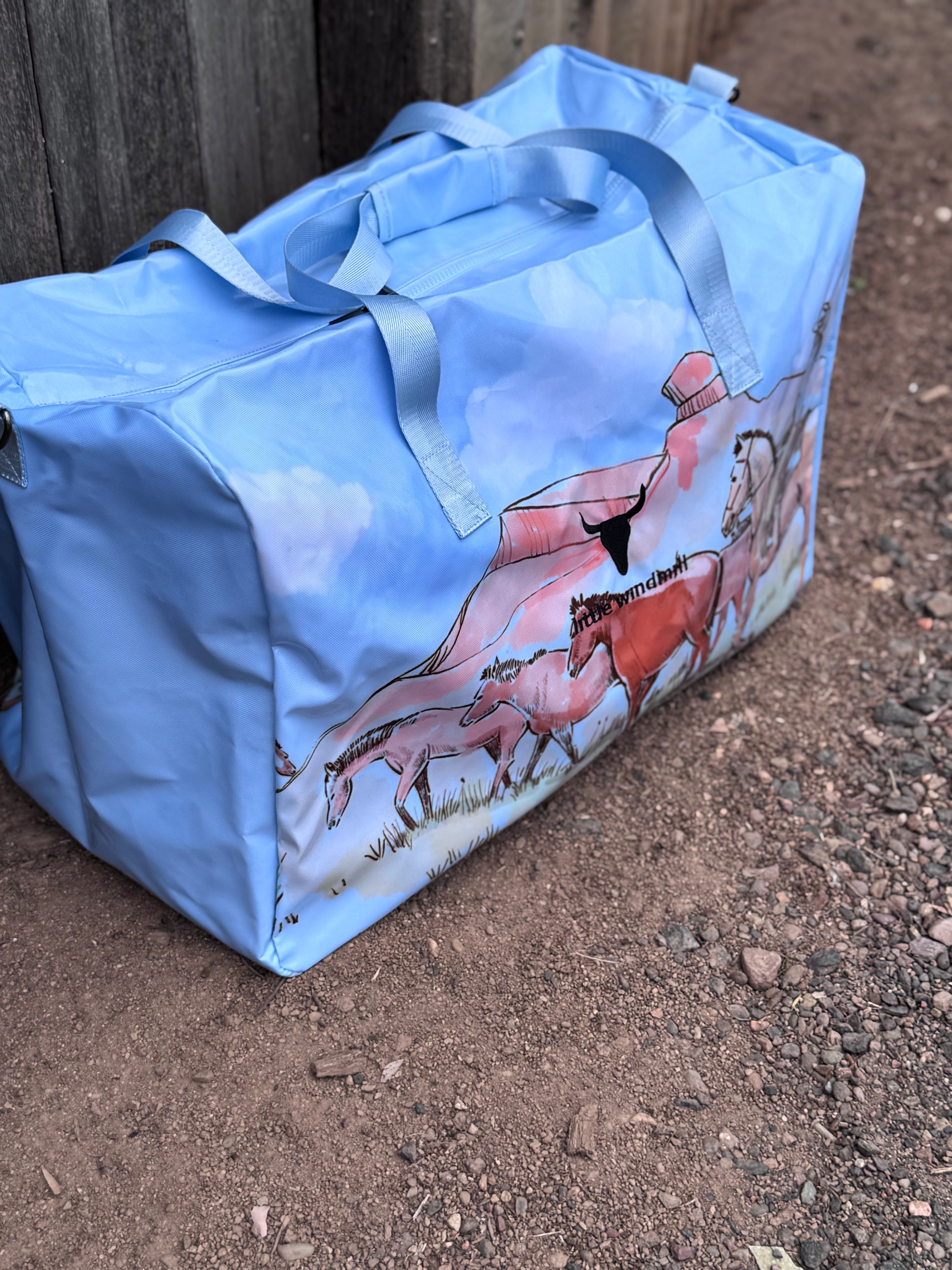 Pastel blue droving duffle bag open showing spacious interior and quality zip closure
