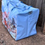 Pastel blue droving duffle bag side view showing roomy compartment and soft blue colourway