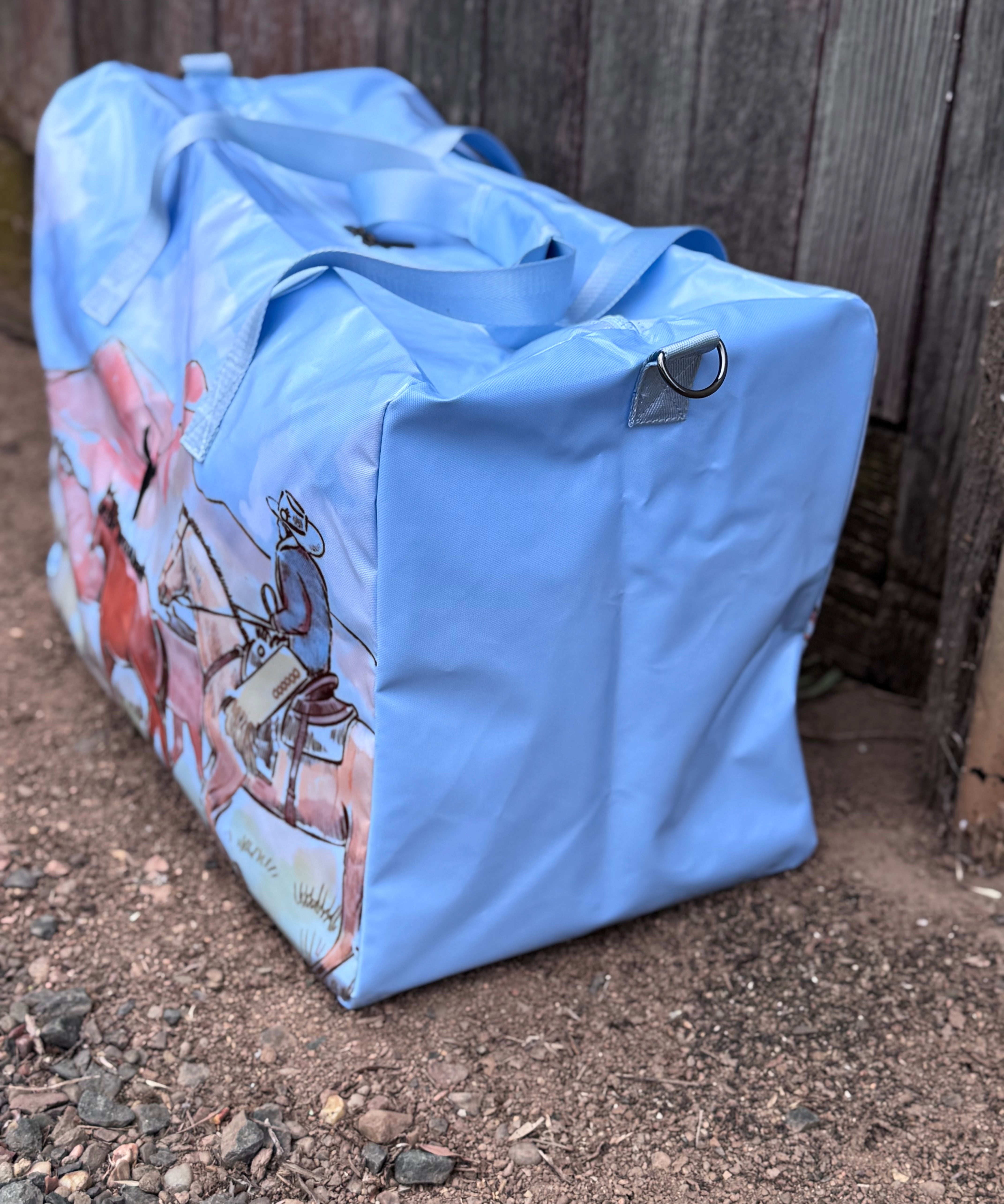 Pastel blue droving duffle bag side view showing roomy compartment and soft blue colourway