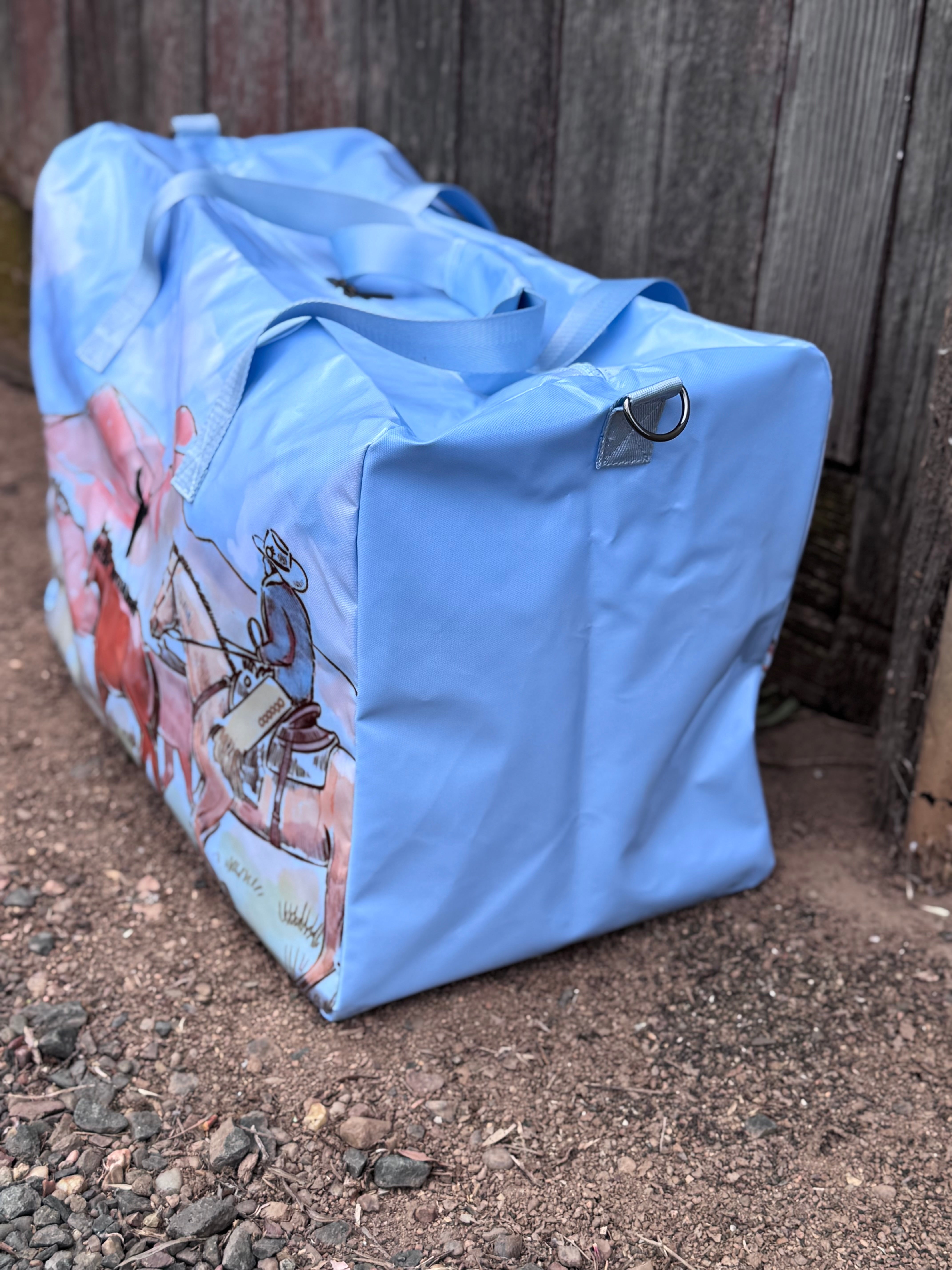 Pastel blue droving duffle bag side view showing roomy compartment and soft blue colourway