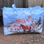 Pastel blue droving duffle bag front view showing cool pastel blue western droving print travel bag