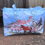 Pastel blue droving duffle bag front view showing cool pastel blue western droving print travel bag