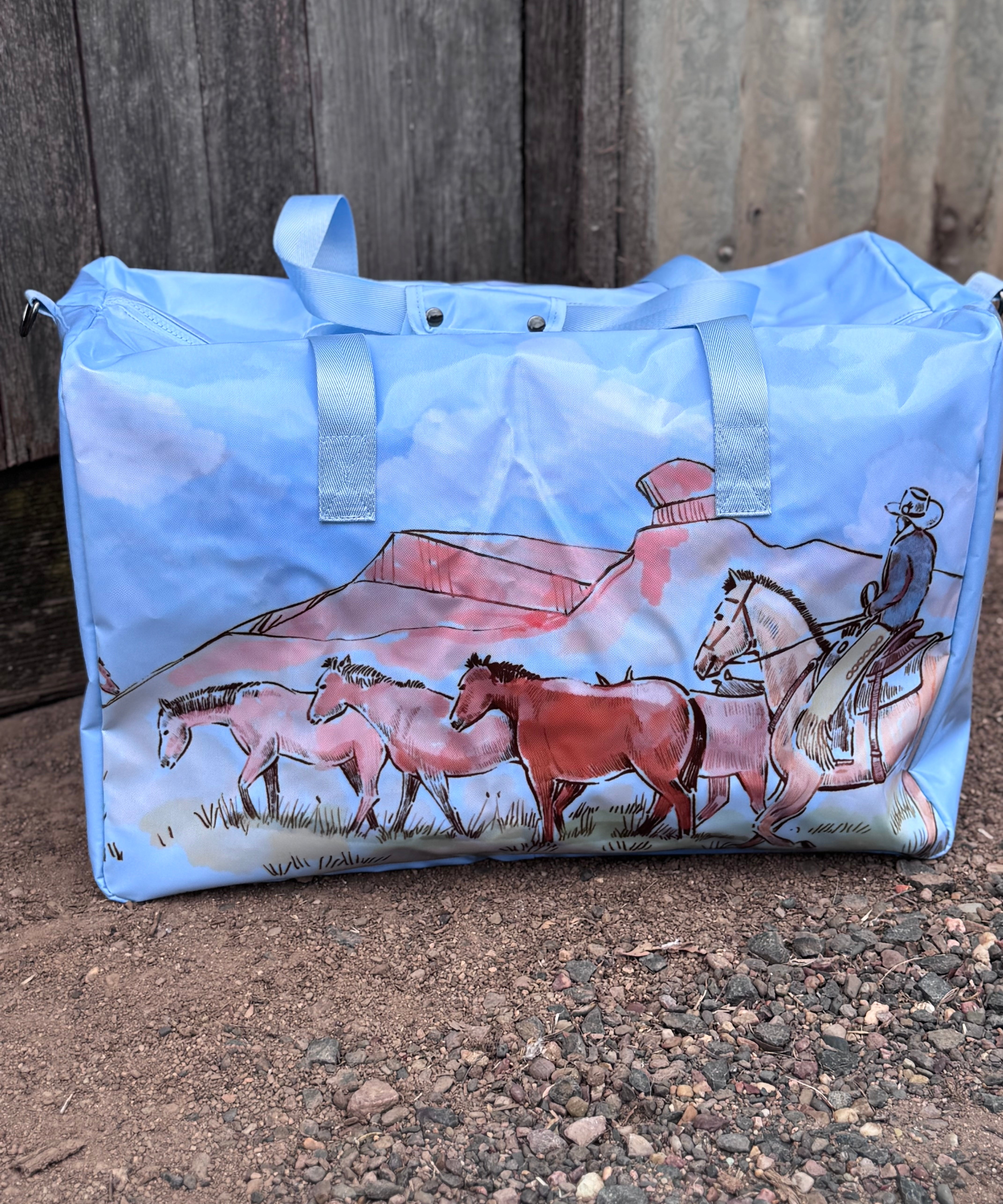 Pastel blue droving duffle bag front view showing cool pastel blue western droving print travel bag