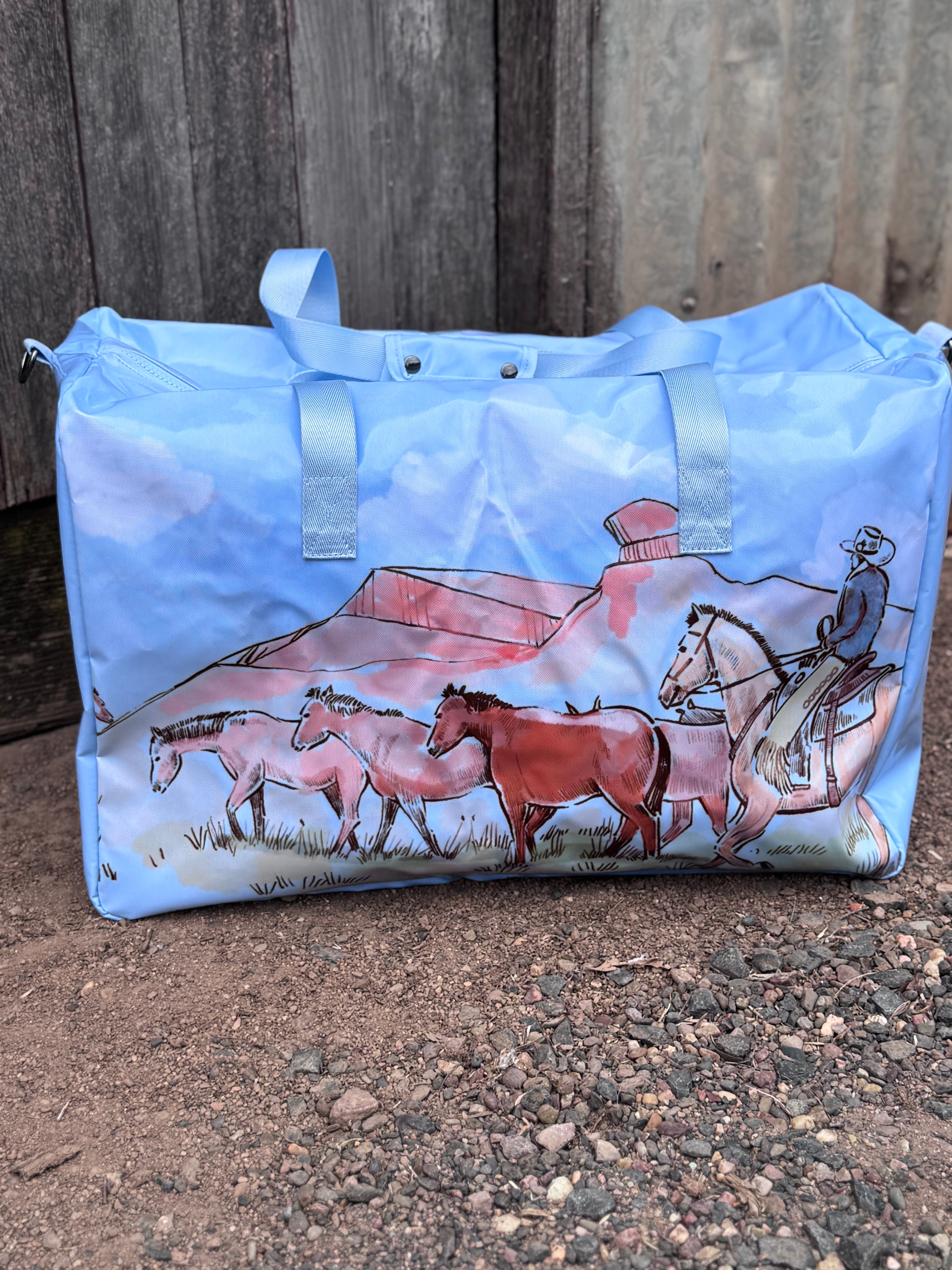 Pastel blue droving duffle bag front view showing cool pastel blue western droving print travel bag