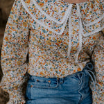 Britt yellow floral women's shirt side view showing relaxed fit and vibrant yellow floral pattern