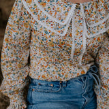 Britt yellow floral women's shirt side view showing relaxed fit and vibrant yellow floral pattern