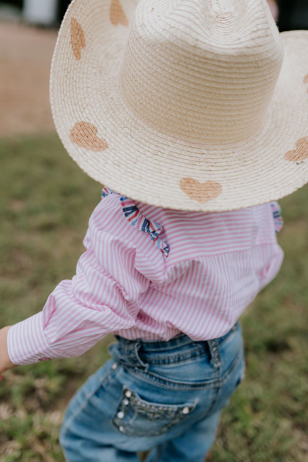 Lara multi stripe pink ruffle long sleeve romper flatlay showing full pink stripe ruffle design