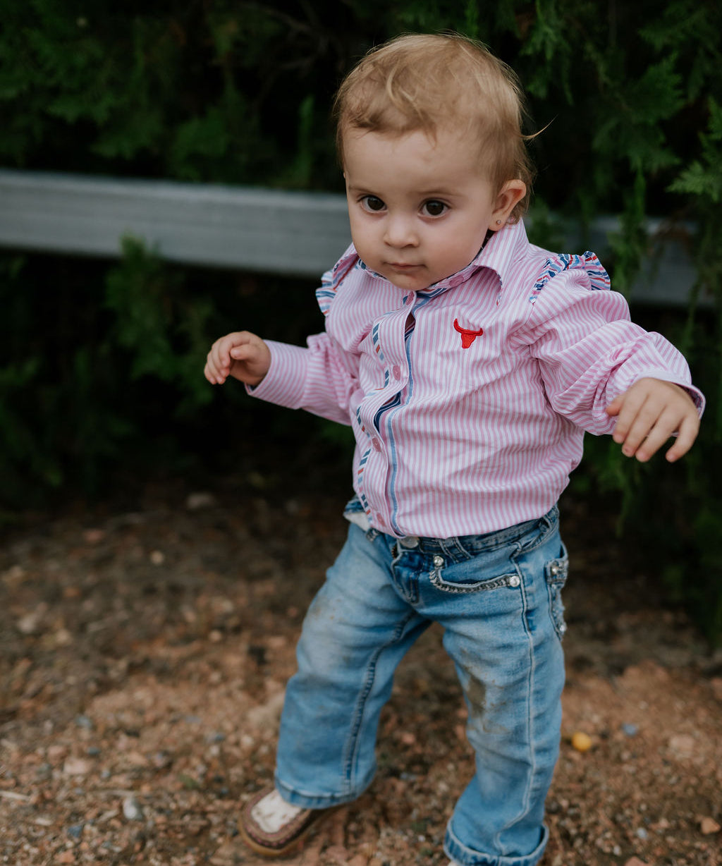 Lara multi stripe pink ruffle long sleeve romper front view showing sweet pink stripe romper with ruffle for toddlers
