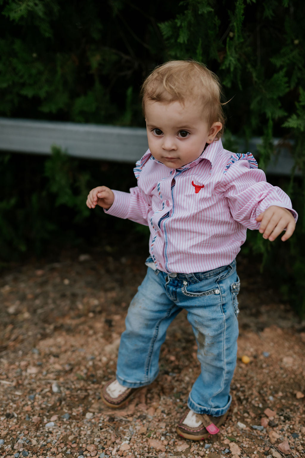 Lara multi stripe pink ruffle long sleeve romper front view showing sweet pink stripe romper with ruffle for toddlers