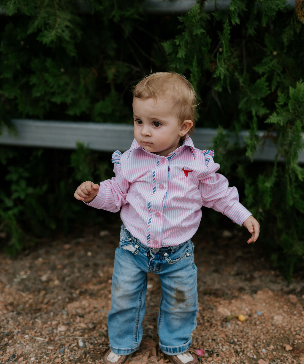 Lara multi stripe pink ruffle long sleeve romper back view showing snap closure and pink stripe ruffle