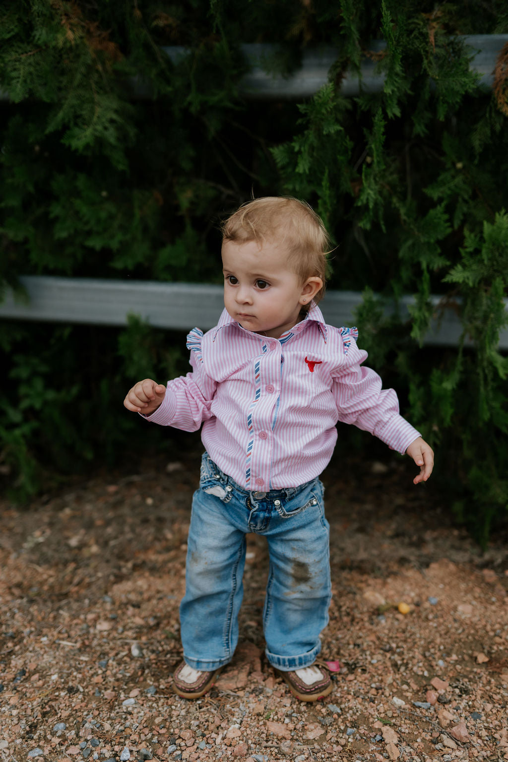 Lara multi stripe pink ruffle long sleeve romper back view showing snap closure and pink stripe ruffle