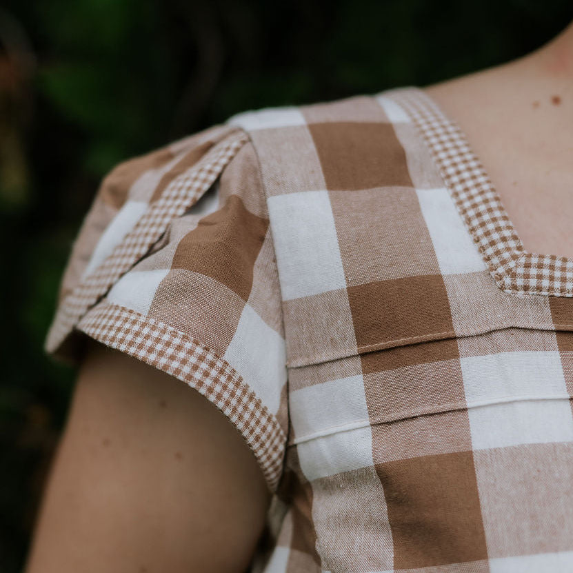 Dusty gingham women's blouse collar detail showing neat collar and button placket in dusty check