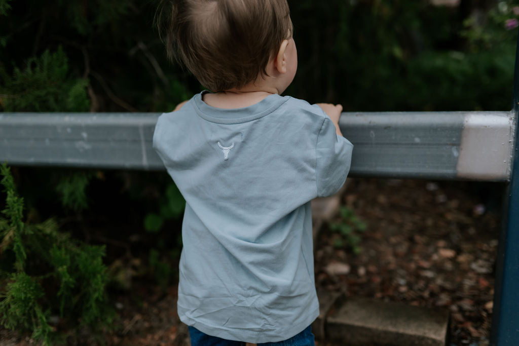 LWCC embroidered kids tee powder blue back view showing relaxed fit and sweet powder blue
