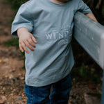LWCC embroidered kids tee powder blue flatlay showing full design and soft powder blue colourway