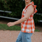 Orange check linen women's blouse side view showing relaxed linen shirt silhouette