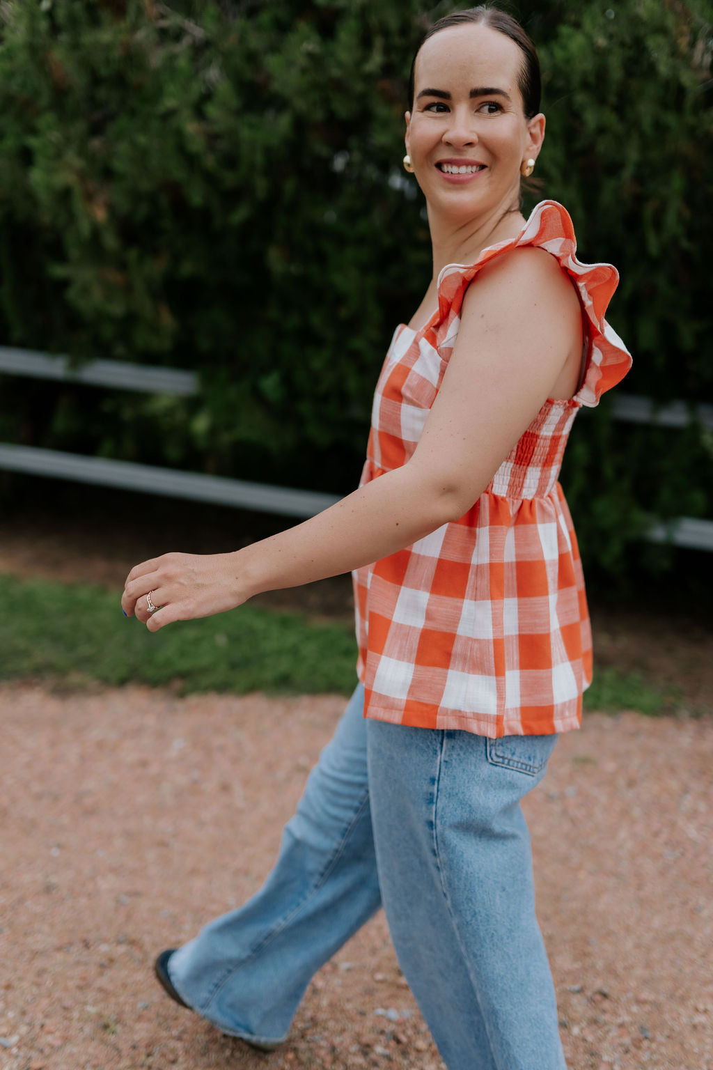 Orange check linen women's blouse side view showing relaxed linen shirt silhouette