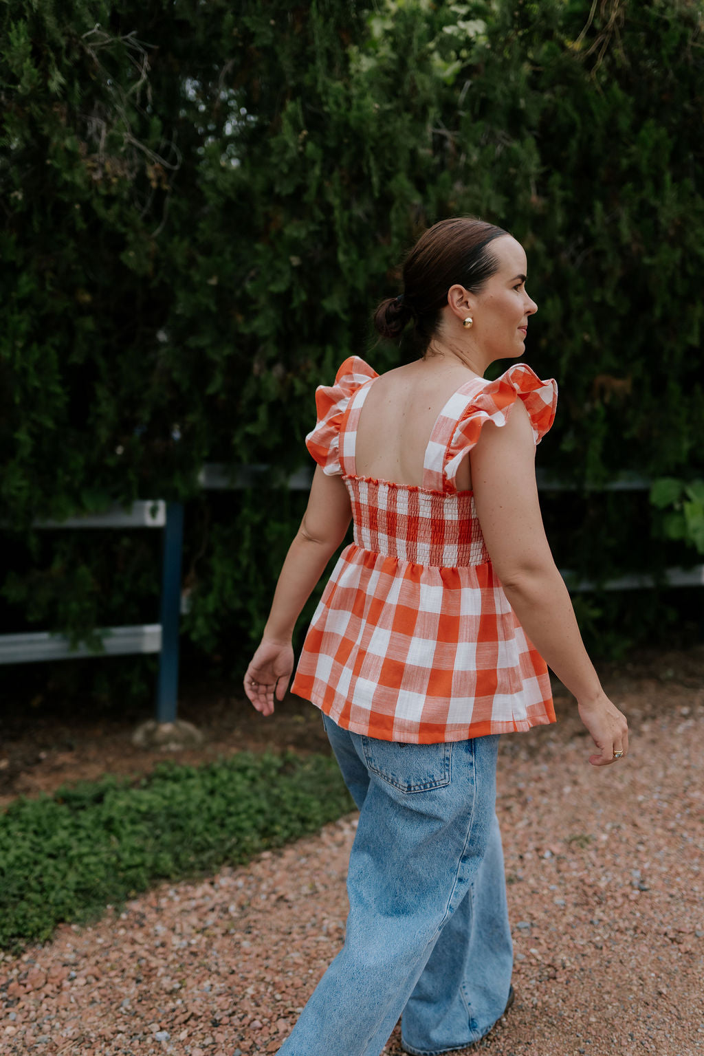 Orange check linen women's blouse back view showing relaxed women's fit in warm orange check linen