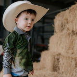 Child wearing a cowboy hat in a barn setting