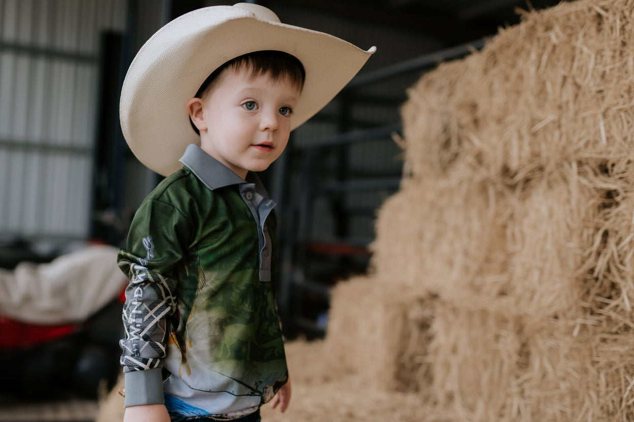 Child wearing a cowboy hat in a barn setting