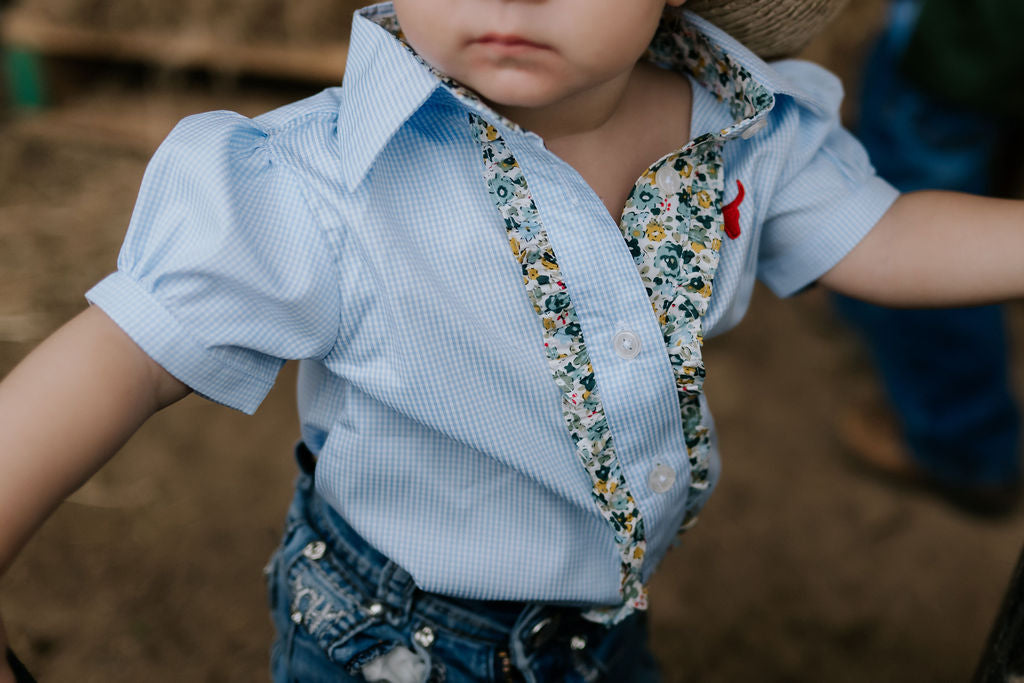 Dasha soft baby blue gingham short sleeve romper worn showing adorable soft blue check country style