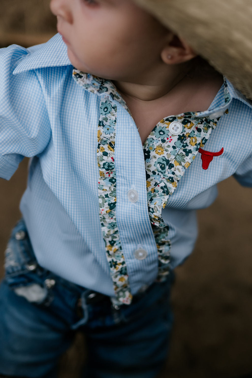 Dasha soft baby blue gingham short sleeve romper fabric close-up showing quality soft blue gingham