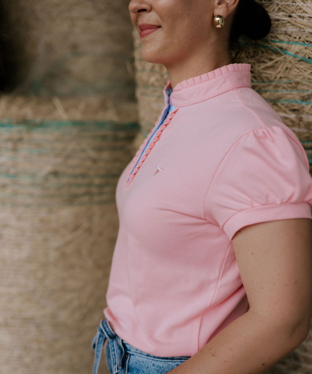 KK pink ruffled collar women's polo shirt front view showing pretty pink polo with ruffle collar detail