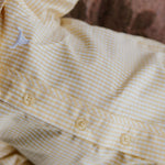 Sunshine lemon long sleeve romper back view showing snap closure and sunny lemon yellow