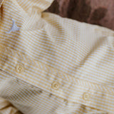 Sunshine lemon long sleeve romper back view showing snap closure and sunny lemon yellow