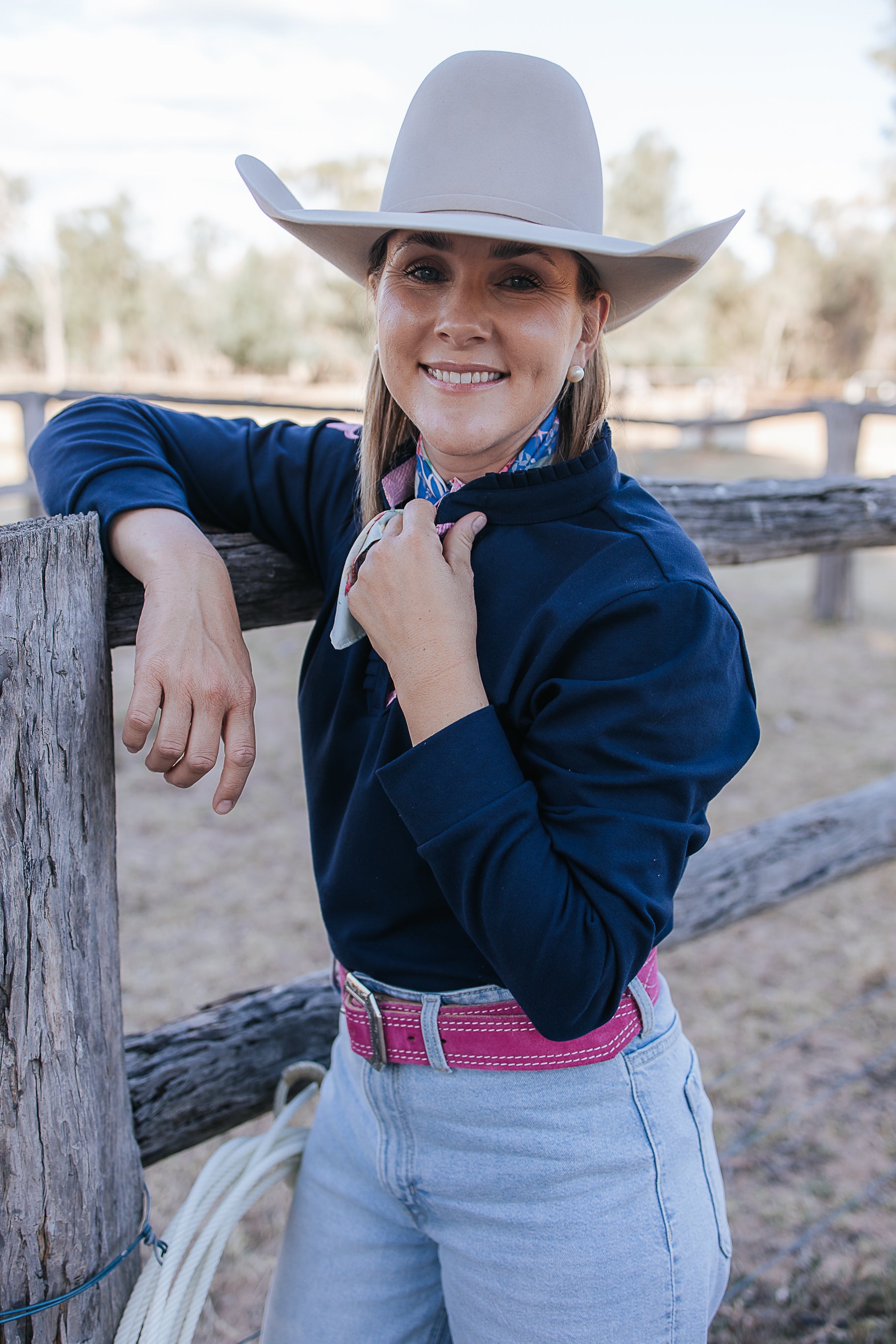 Bella women's long sleeve navy gingham ruffle collar contrast polo front view showing elegant navy gingham women's polo