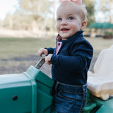 BB Baby navy ruffle pink gingham contrast long sleeve baby polo romper fabric close-up showing quality gingham cotton