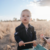 Brad Baby navy contrast long gingham baby polo romper worn showing smart navy gingham country style for baby
