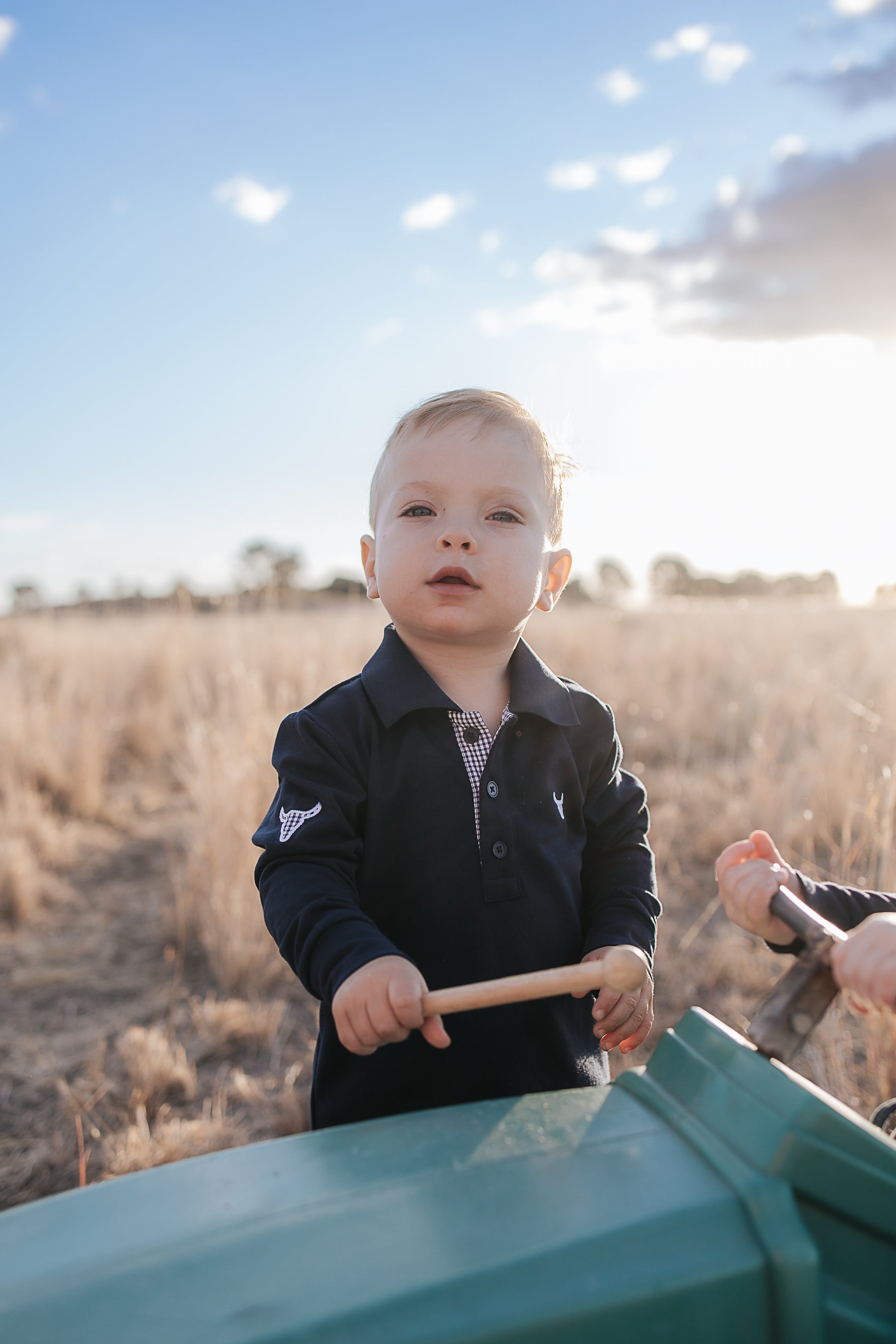 Brad Baby navy contrast long gingham baby polo romper worn showing smart navy gingham country style for baby