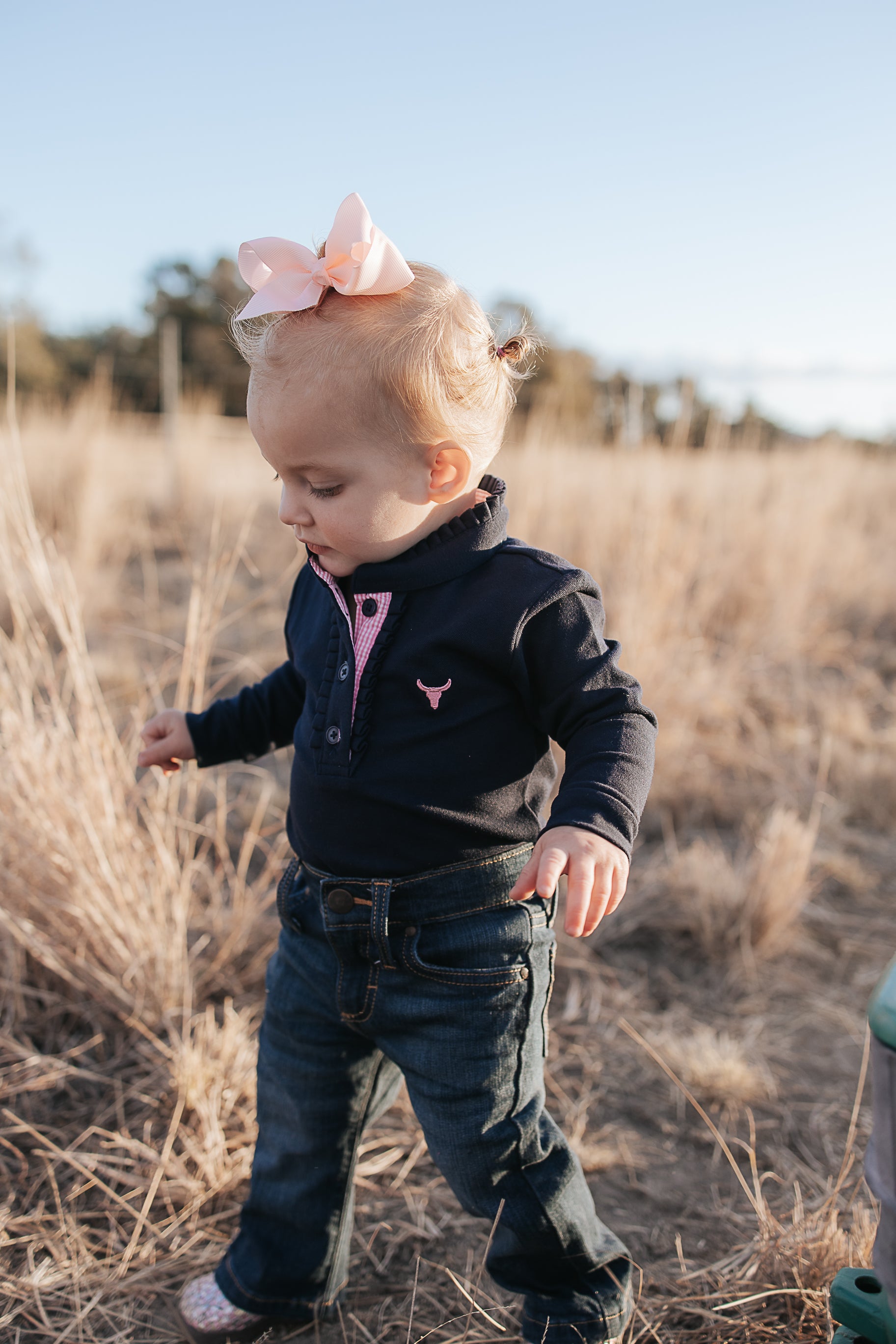 BB Baby navy ruffle pink gingham contrast long sleeve baby polo romper front view showing adorable baby navy pink gingham romper