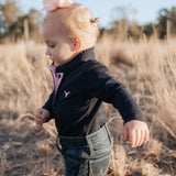 BB Baby navy ruffle pink gingham contrast long sleeve baby polo romper back view showing snap closure and baby fit