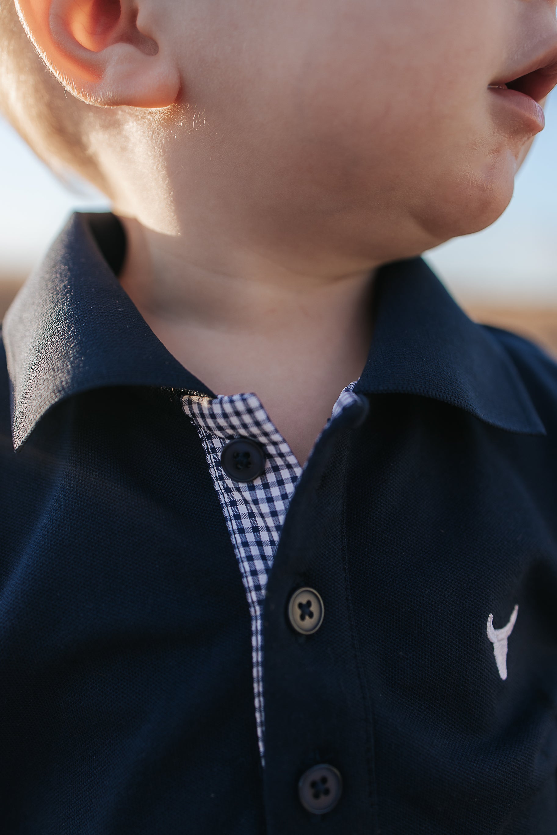 Bandon Jnr navy gingham contrast long sleeve polo back view showing relaxed boys fit in navy gingham