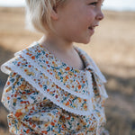 Elsie girls butter yellow floral long sleeve blouse flatlay showing full butter yellow floral design