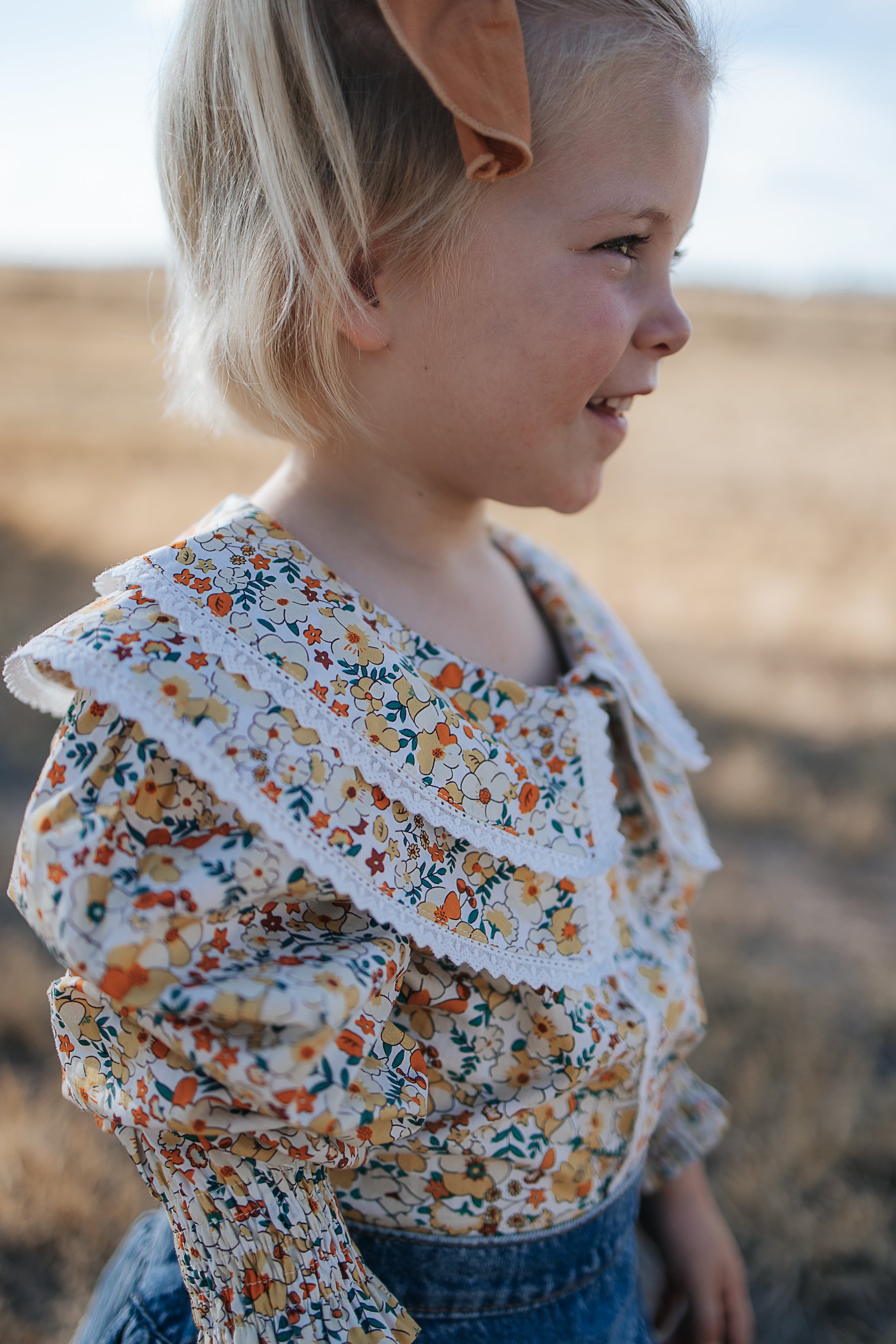 Elsie girls butter yellow floral long sleeve blouse flatlay showing full butter yellow floral design