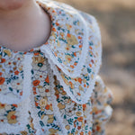 Elsie girls butter yellow floral long sleeve blouse fabric close-up showing quality yellow floral cotton