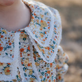 Elsie girls butter yellow floral long sleeve blouse fabric close-up showing quality yellow floral cotton