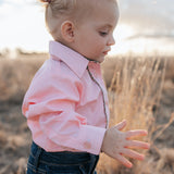 Chloe coral gingham long sleeve romper back view showing snap closure and coral gingham fabric