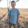 LWCC embroidered kids tee powder blue front view showing signature LWCC logo on soft powder blue