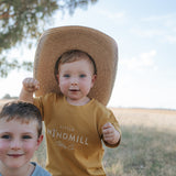 LWCC embroidered kids tee mustard embroidery close-up showing detailed LWCC logo stitch on mustard
