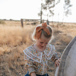 Elsie girls butter yellow floral long sleeve blouse worn by girl showing charming yellow floral country style