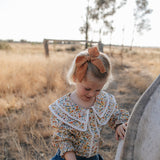 Elsie girls butter yellow floral long sleeve blouse worn by girl showing charming yellow floral country style
