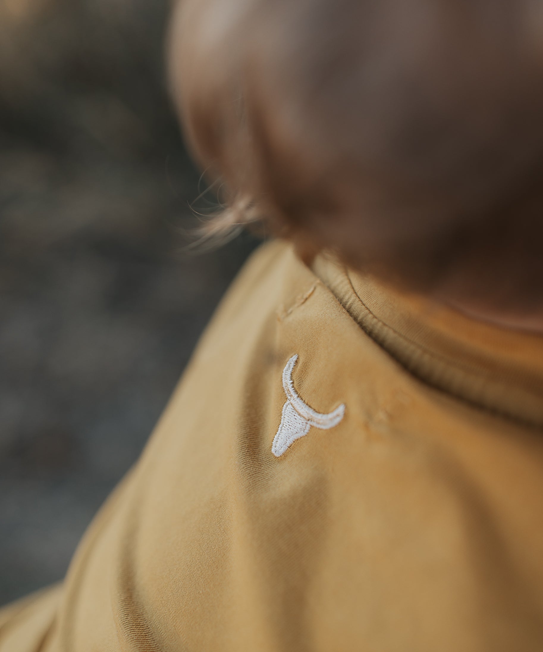 LWCC embroidered kids tee mustard back view showing relaxed fit and bold mustard colourway
